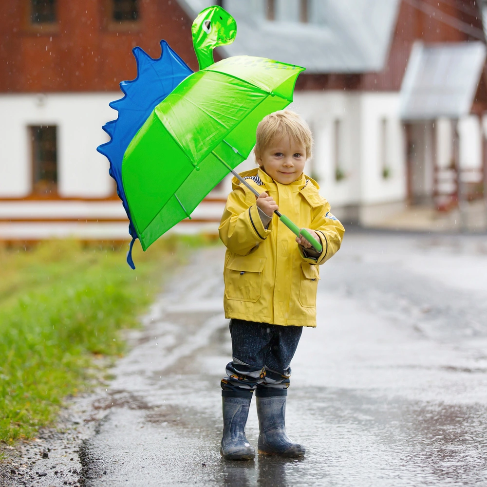 Children using colorful umbrellas in the rain
