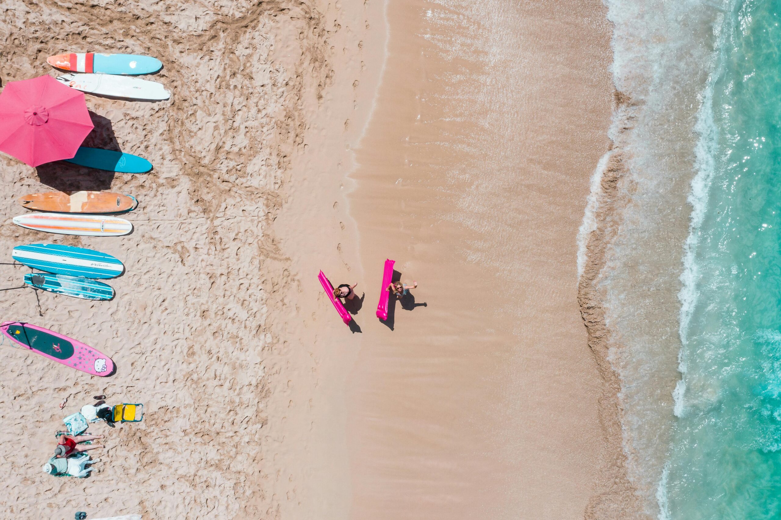 Aerial shot of surfers and surfboards on Waikiki Beach in Honolulu, Hawaii. Vivid summer vibes.
